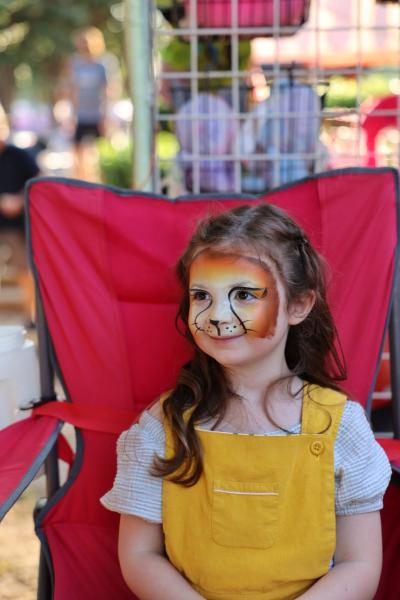 Girl getting face paint at Taste Addison