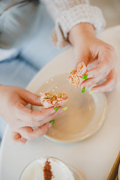 A girl pulling apart a macaroon at Mjomii Dessert & Coffee House