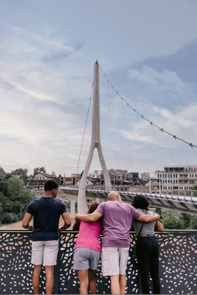 A family in Riverside Crossing Park looking out at the Dublin Link pedestrian bridge