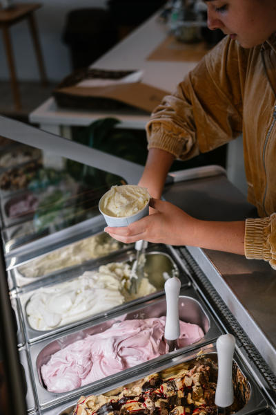 A young woman scooping ice cream at The Dreamery in downtown Elizabethtown