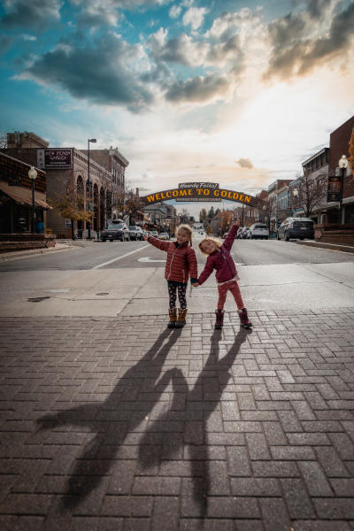 Children posing in front of Golden's Welcome Arch