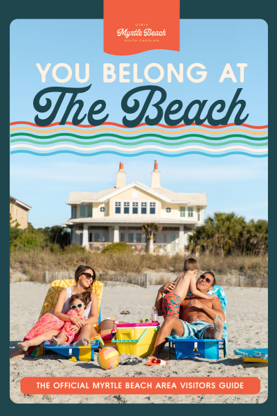 Family sitting on The Beach in front of beach house, You Belong At The Beach