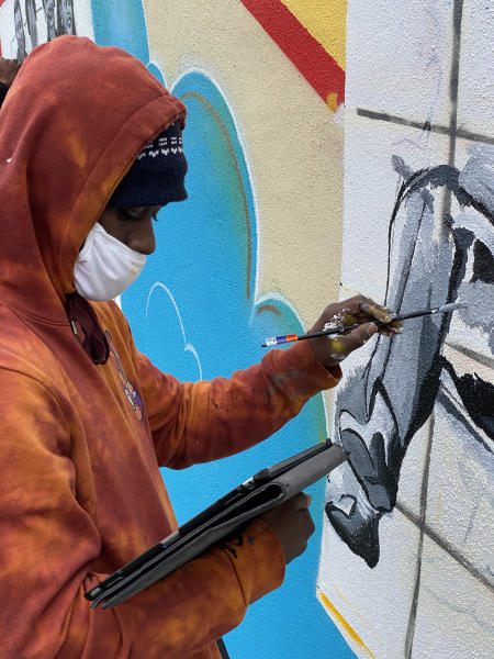 Deonte Ward paints a mural of Carr's Beach.