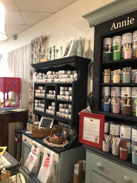 A wall of shelves with chalk paints.