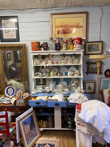 Captain Harvey's shelves packed with vintage finds like tea cups and saucers.