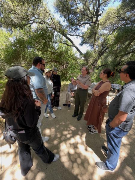 Travelers from the Mexico Reverse Mission listen to a ranger-guided tour of theChitactac-Adams Native American site.