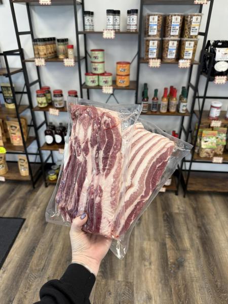 Packaged meat held out in front of sauces