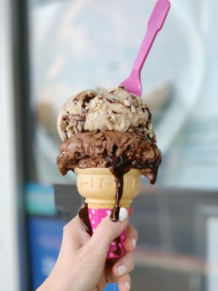 A double scoop of Baskin-Robbins ice cream with chocolate sauce dripping down.