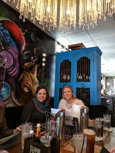 two women eating in front of artwork at agave and rye in covington ky