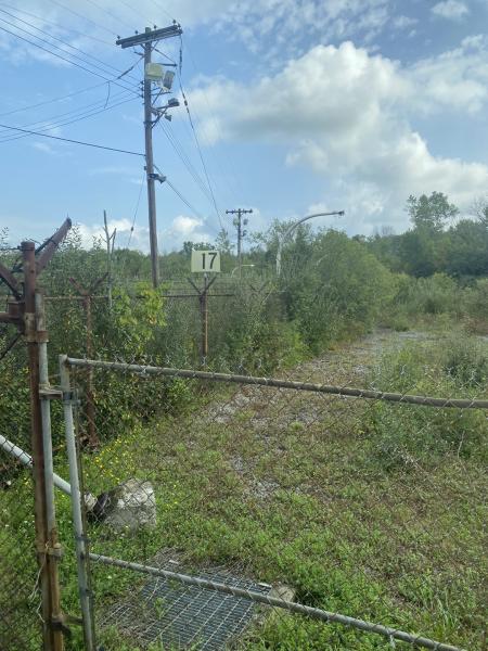 fenced off area with telephone pole and camera