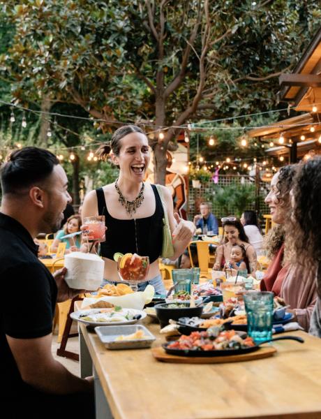 Four friends enjoy an array of fajitas, ceviches, and dips alongside margaritas and coconut cocktails at La Cosecha restaurant in Downtown Sacramento.