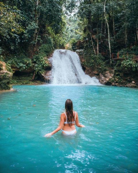 Woman in front of a waterfall