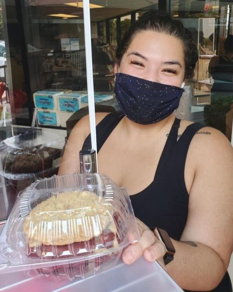 Teresa Gee owner of Gigis Cafe in Burlingame showing off one of her pastries