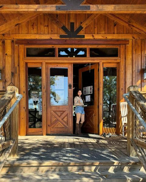 A guest stands at the door of Giddy Up Folsom.