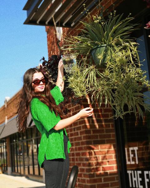 Umber Shoppe employee modeling a green shirt