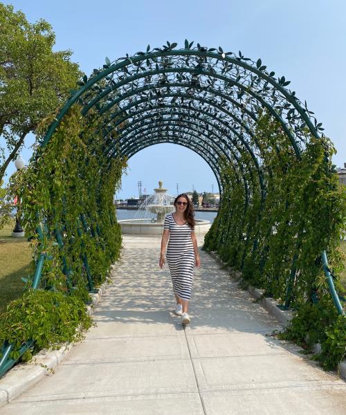 Woman walking under the arbor at Shipbuilders Company Park in Manitowoc Wisconsin