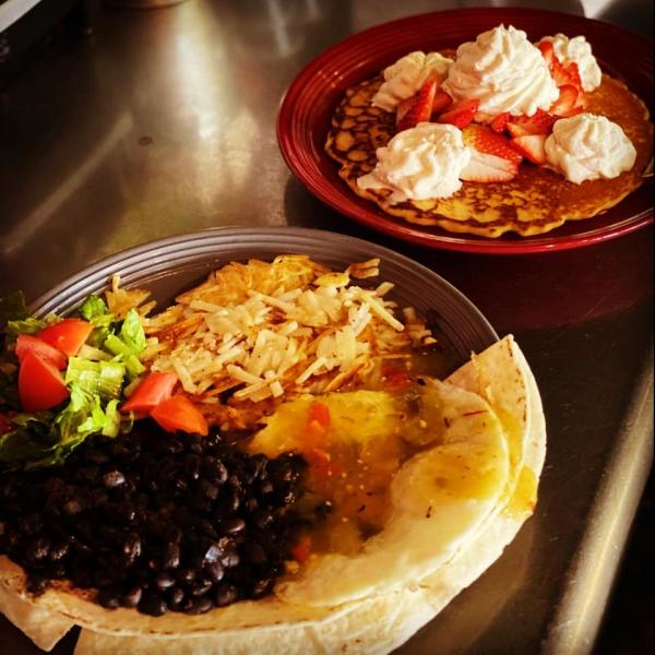 A plate of Mexican food and a plate of pancakes from Java Joe's