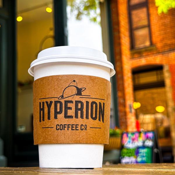 cup of hyperion coffee sitting on table outdoors