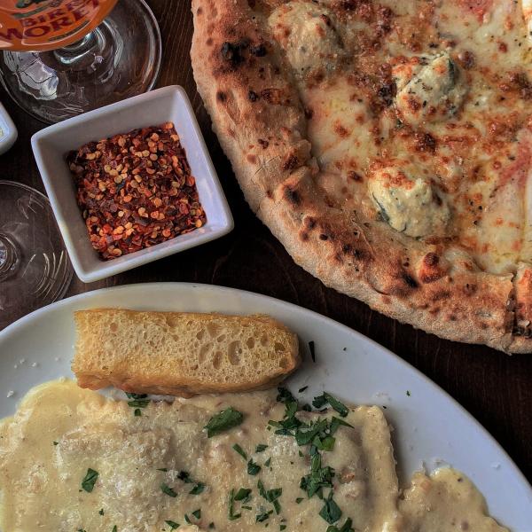 A pizza and a ravioli dish from Osteria Rago