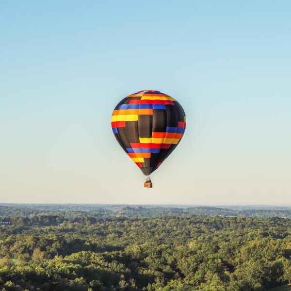 A hot air balloon floating over Bloomington's countryside