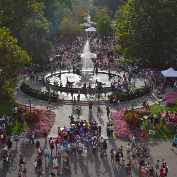 A crowd of people around Showalter Fountain during a First Thursdays event