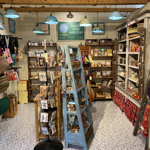 The Greater Goods Marketplace display found at BrickCity, Fort Smith, Arkansas featuring three shelves arranged back-to-back, surrounded by additional shelves lining the walls.