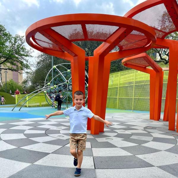 A child enjoys the play area at Levy Park in Houston, TX