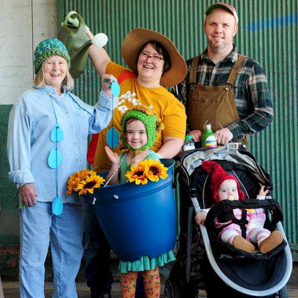 Family dressed in creative Halloween costumes poses together during Trick or Treat at Lowe Mill ARTS & Entertainment.