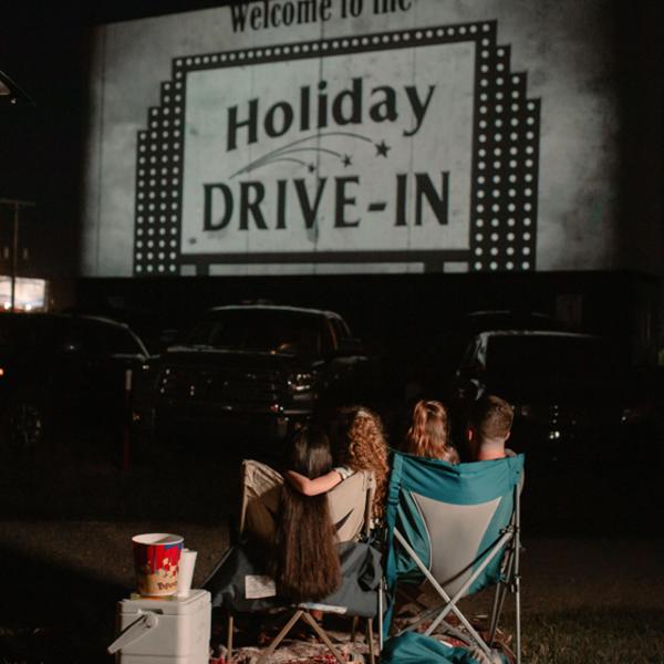 Family watching a Drive IN theater IN Santa Claus, Indiana