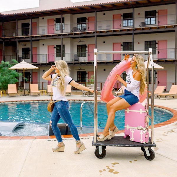 Texican Court girls pulling luggage