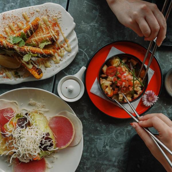 People eating food with chopsticks.