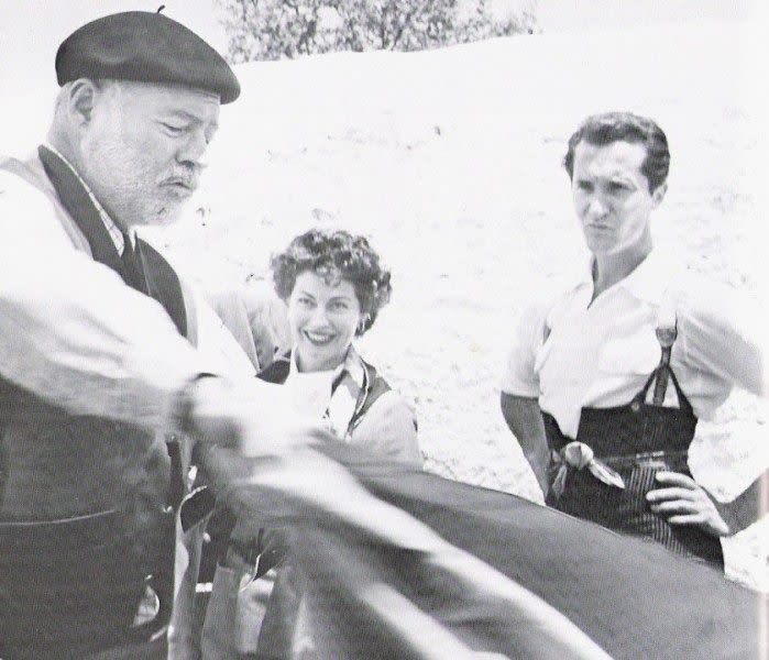 Ernest Hemingway demonstrating his bullfighting technique for Ava Gardner and Luis Dominguin