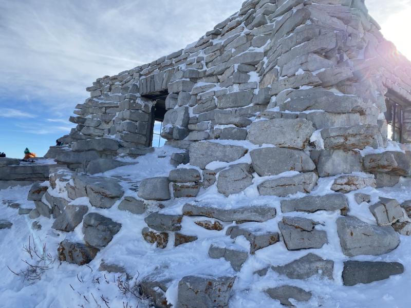 A look at the outside of the Kiwanis cabin, which is made out of stone and covered in snow.