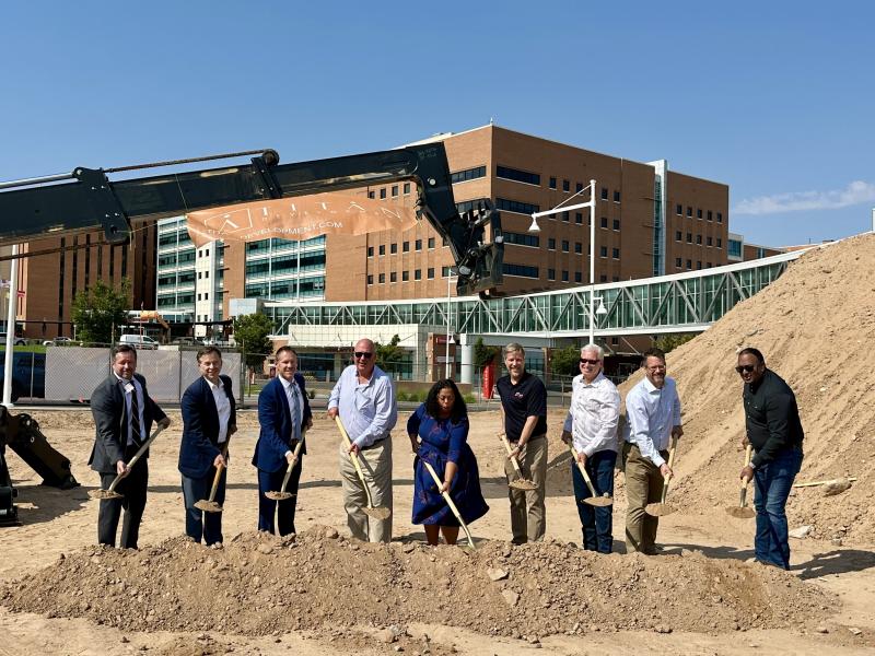 Officials shovel dirt at the Marriott Residence Inn & Highlands Central Market groundbreaking.