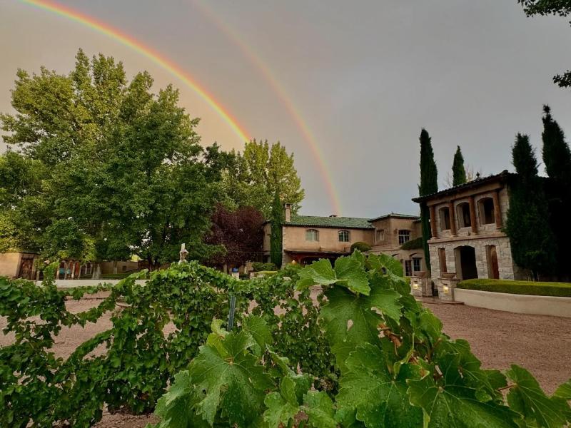 Two rainbows are in the sky over Casa Rondeña Winery.