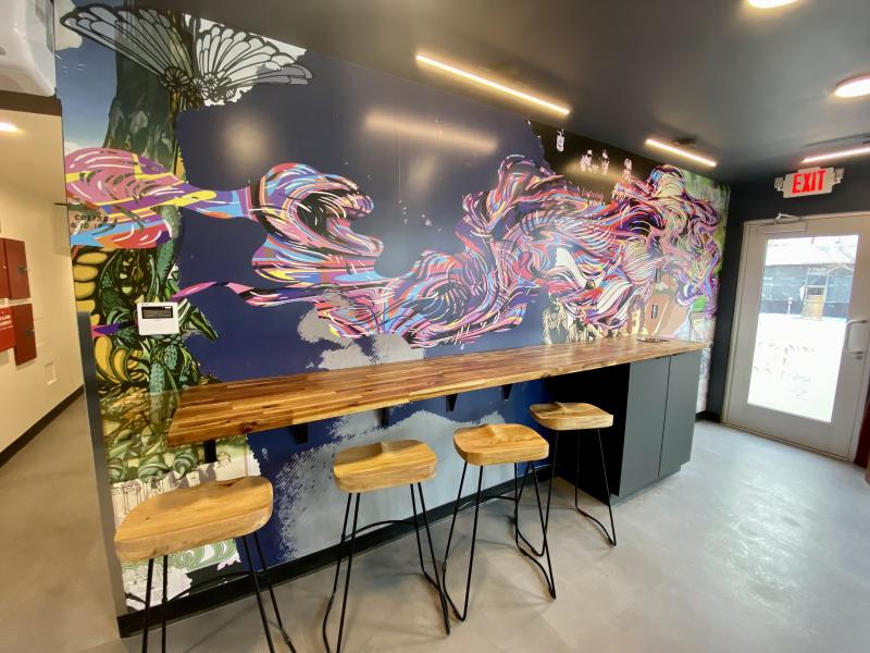 A look at a mural and seats in the Imperial Inn lobby, which doubles as a coffee shop.