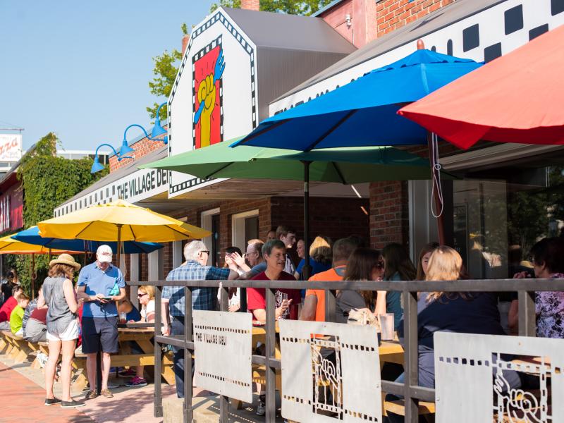People dining on The Village Deli's patio
