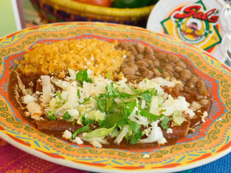 colorful mexican cuisine dish served with rice and beans