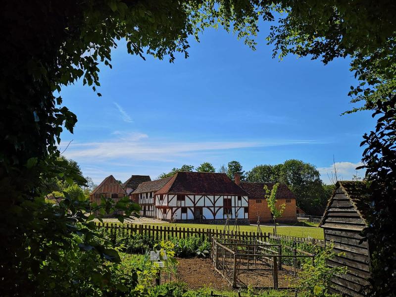 A view of the toll house garden with market square in background at Weald & Downland museum