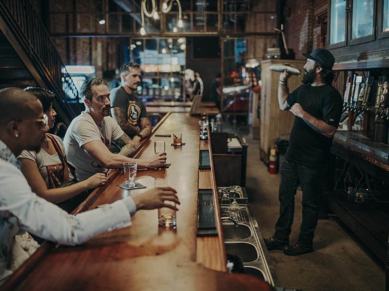 People sitting at the bar at Arcademie in Evansville, Indiana