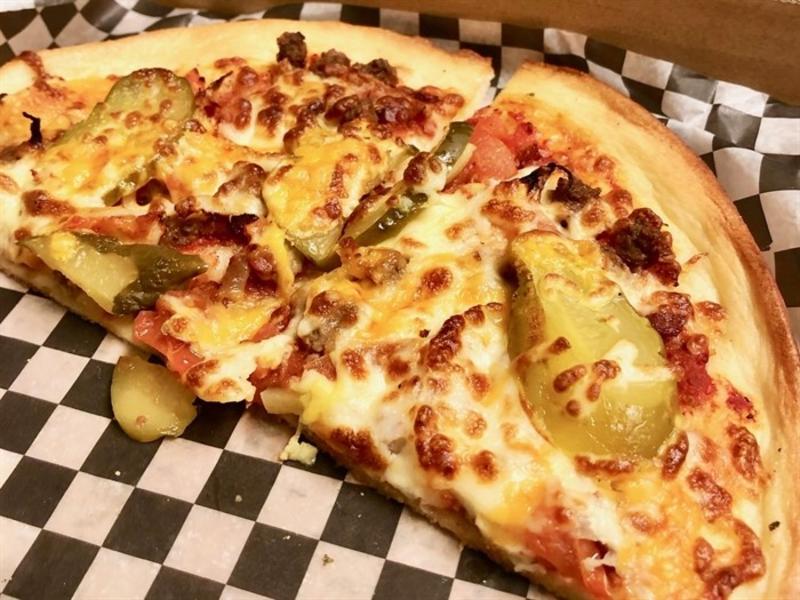 Half of a personal pizza topped with pickles from DunnEnnzies Pizza in Kelowna, BC