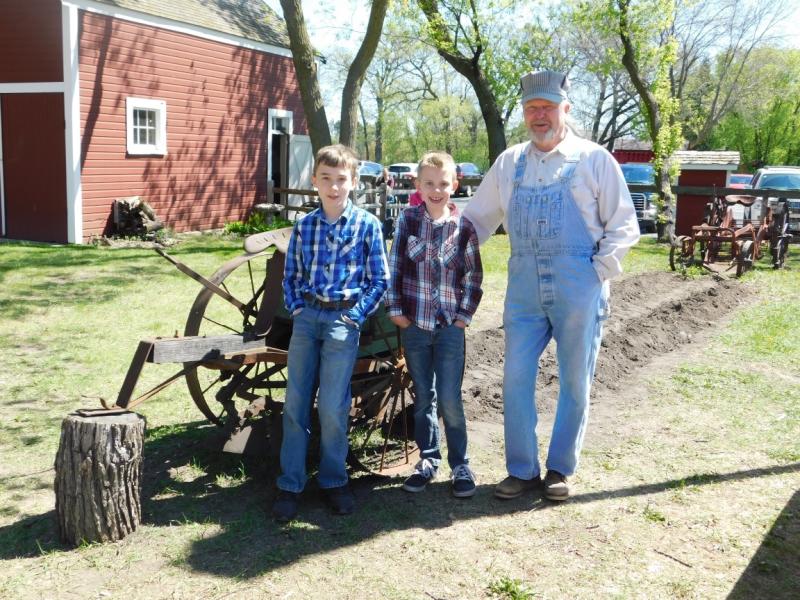 Man and young boys on a spring day at the farm