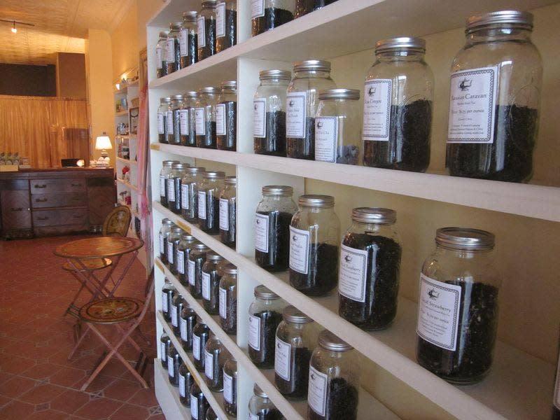 glass jars filled with tea leaves assorted in shelves