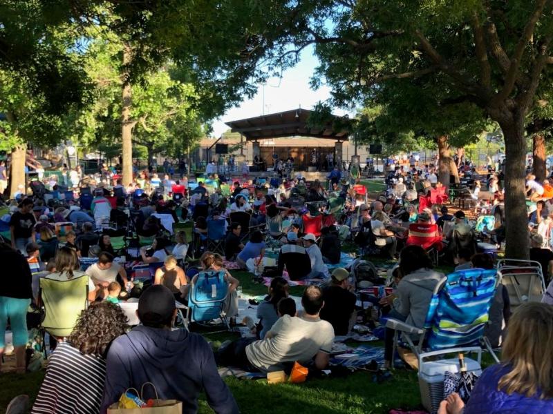 Crowd gathered on the lawn watching Music in the Park in San Carlos, California