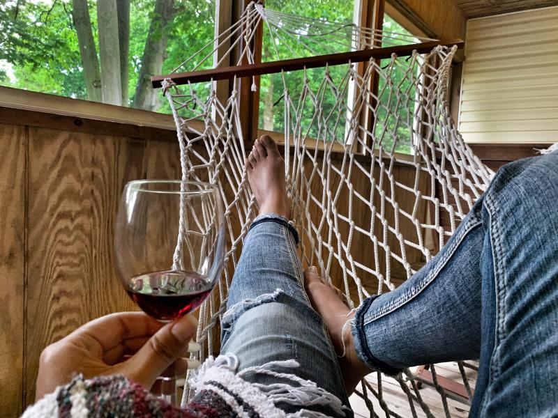 woman in hammock relaxing with wine