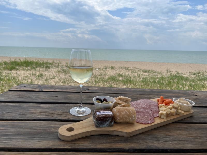 food and wine on beachside picnic table