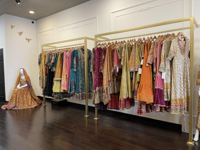 Clothing rack with saris and caftans at Farah Talib Aziz