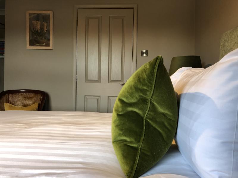 A green colour hotel room with bed at East Beach Guest House, Littlehampton