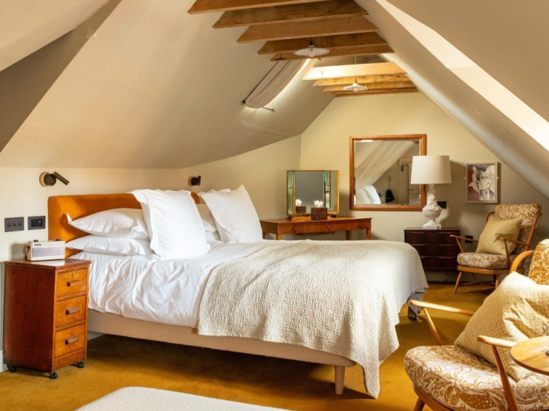 The George Inn,  Rye. Bedroom in a beamed room with cosy white linen and wooden features.