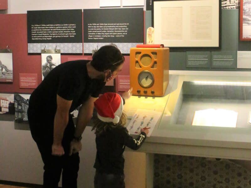 A child and father looking at an exhibit in the Dylan Thomas Centre.